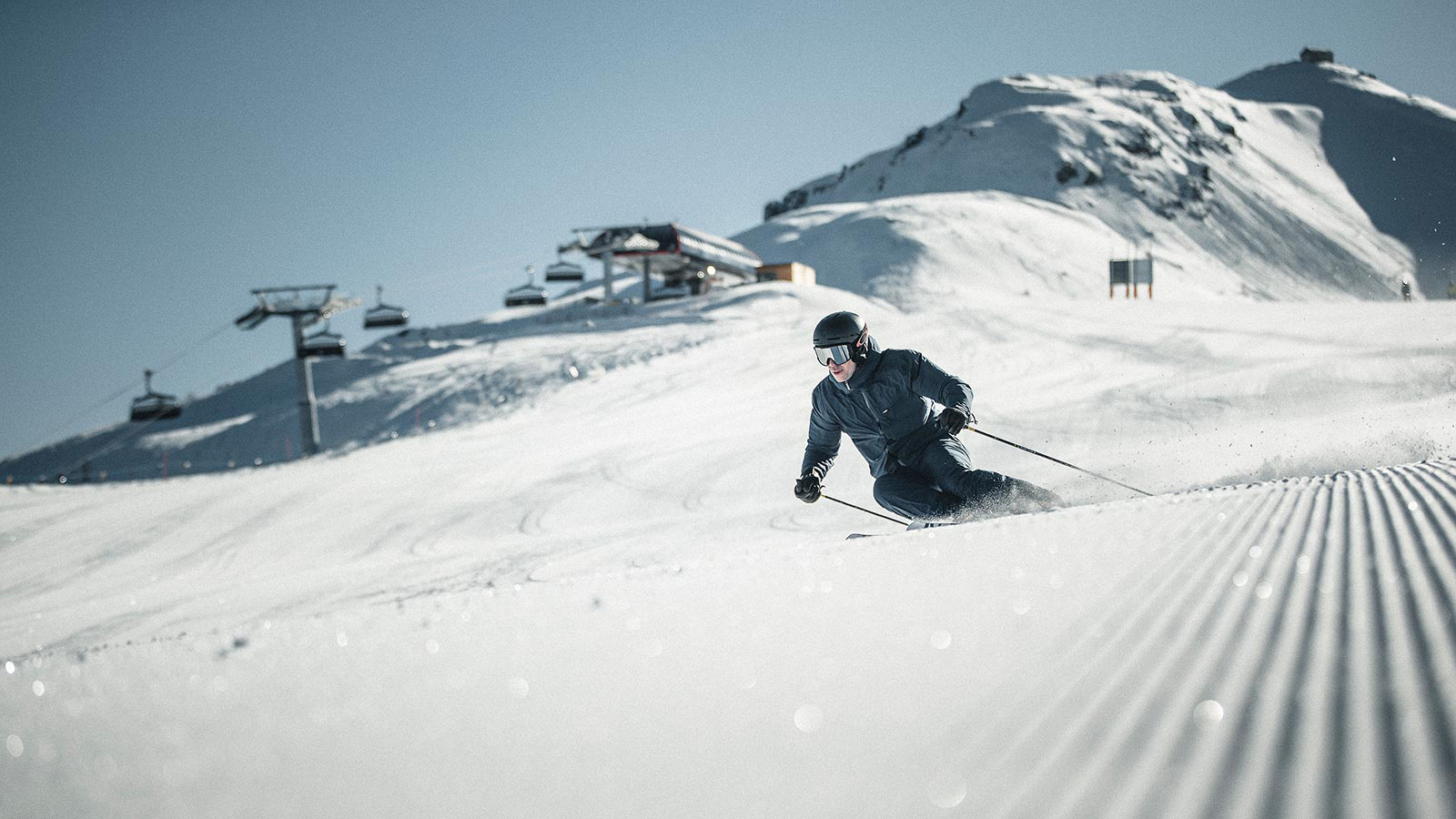 A skier is intent on slaloming down a snowy slope.